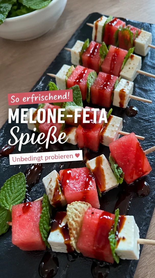 Melone-Feta-Spieße mit frischer Minze auf einem Teller